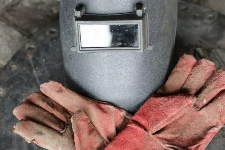 Welding helmet and red welding gloves